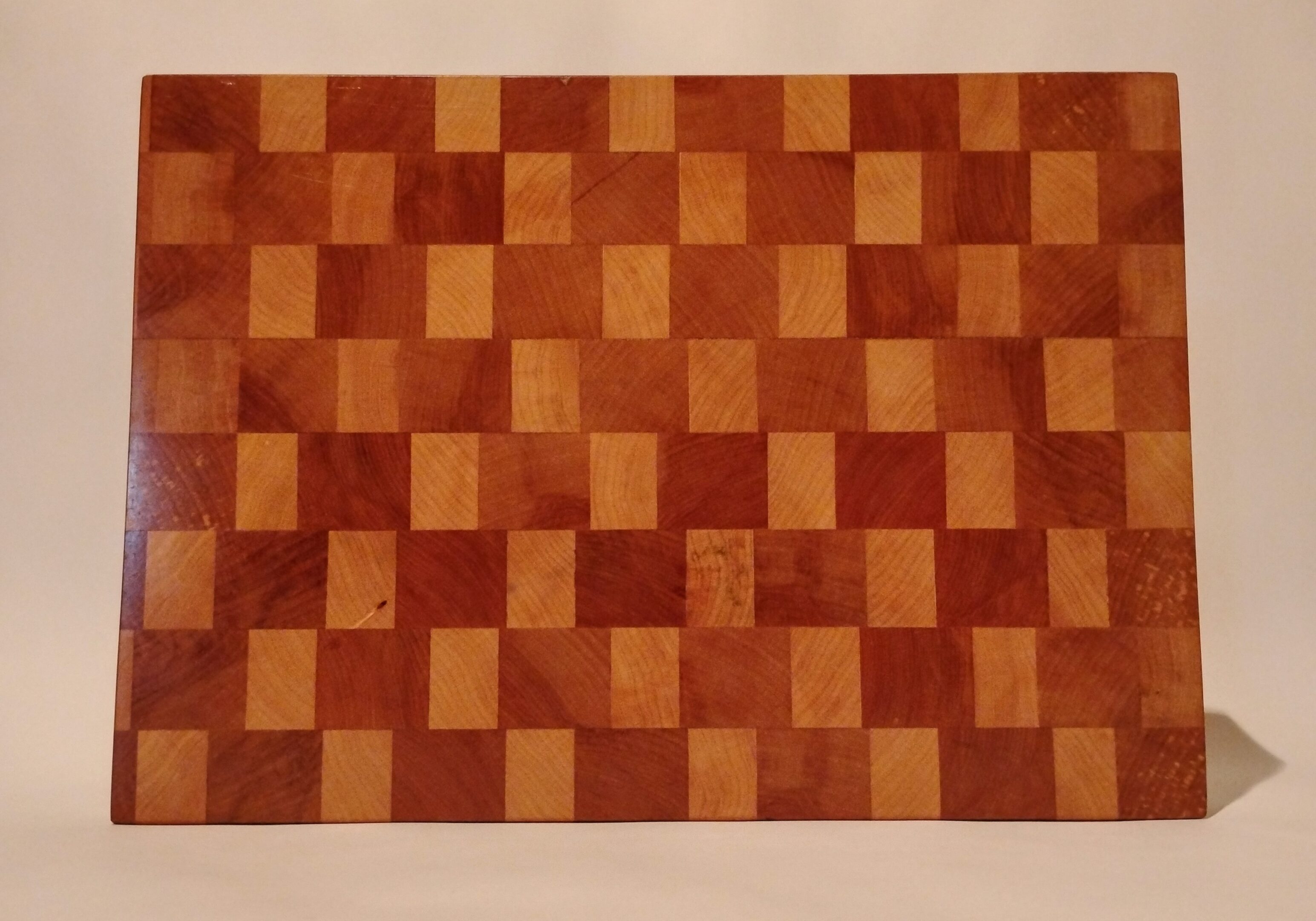Checkerboard pattern with alternating light and dark brown squares.