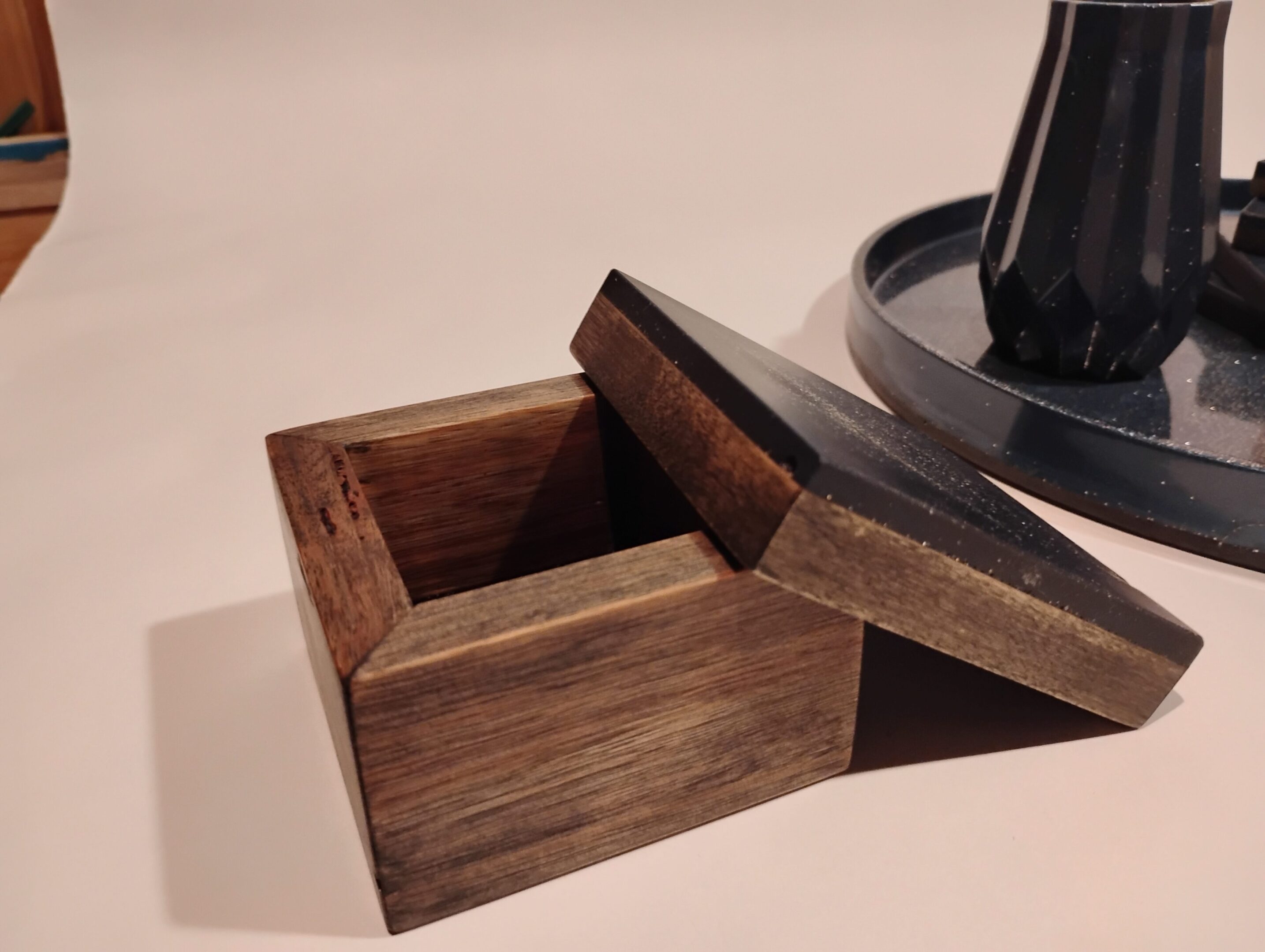 Open wooden box with a removable lid.