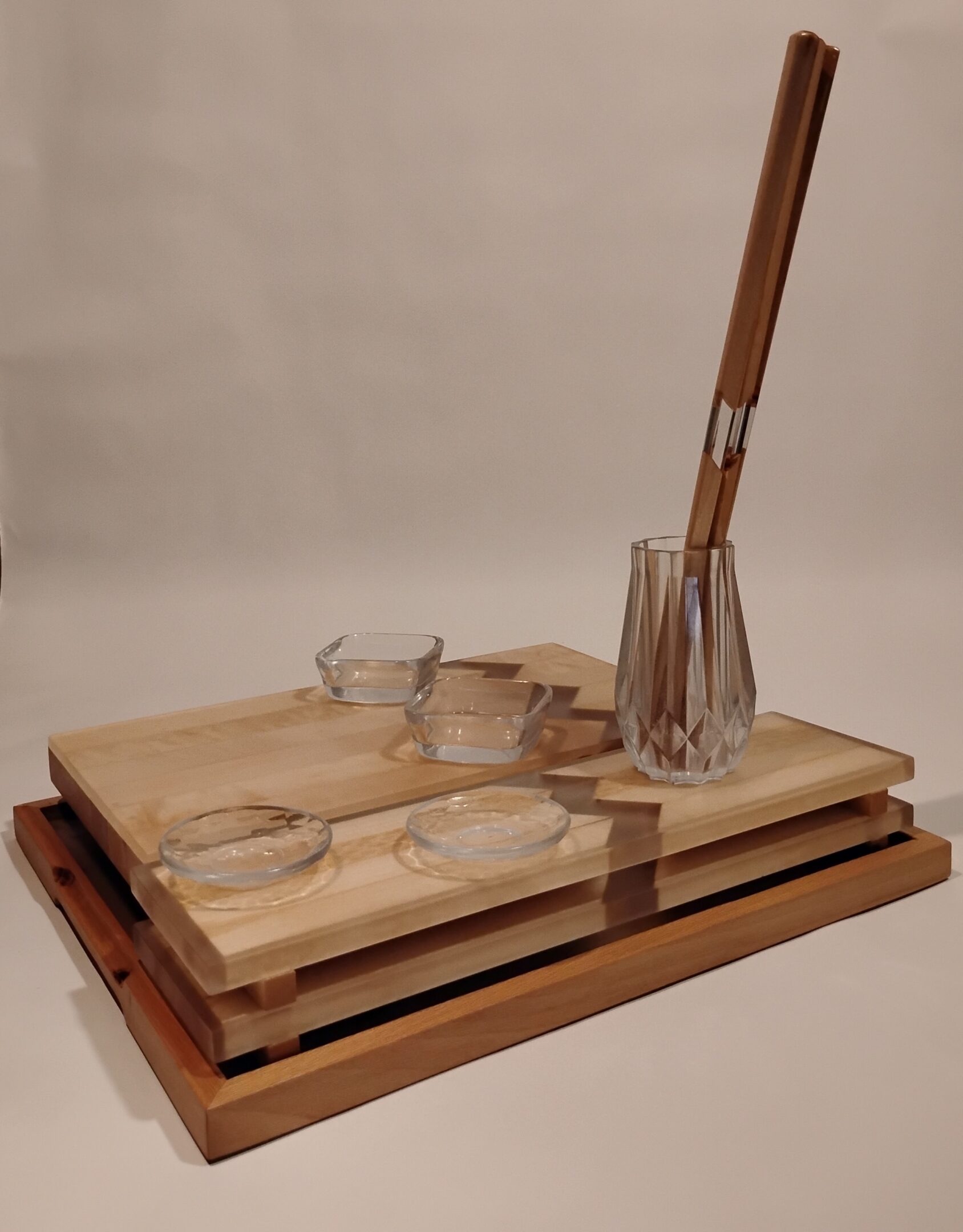 Elegant wooden tray set with glassware and a stirring rod.
