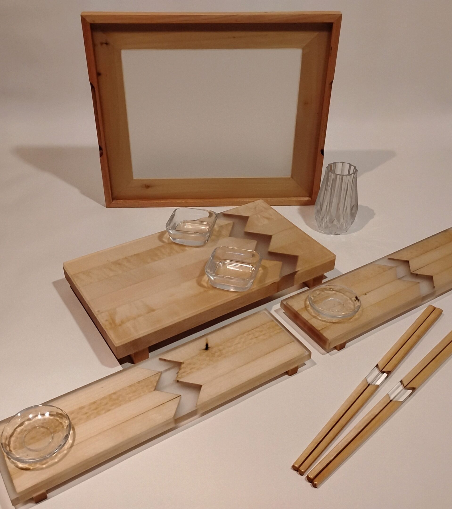 Wooden kitchen tools and a cutting board with a mirror in the background.