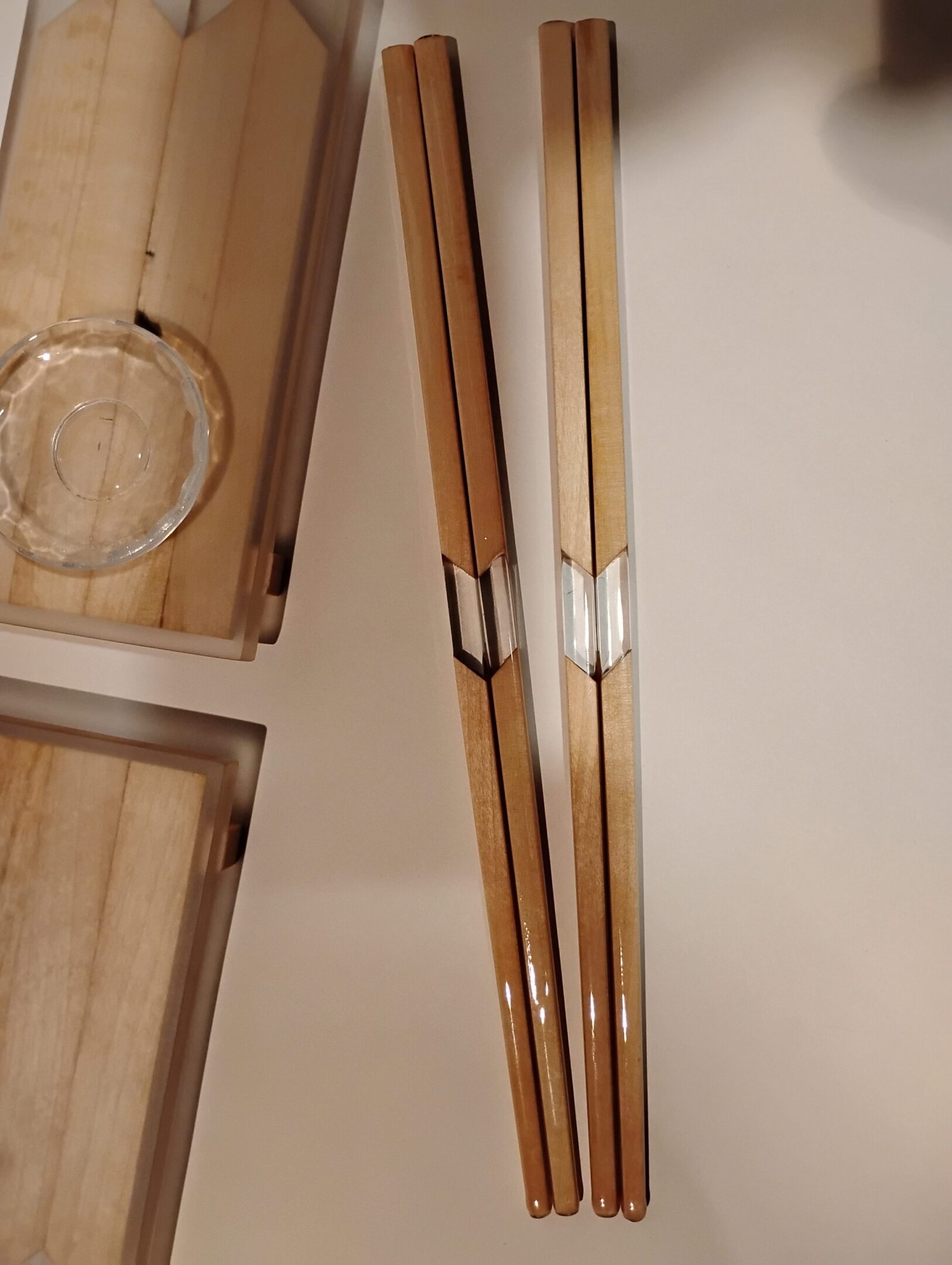 Two wooden arrows with feather fletching and carved grips.