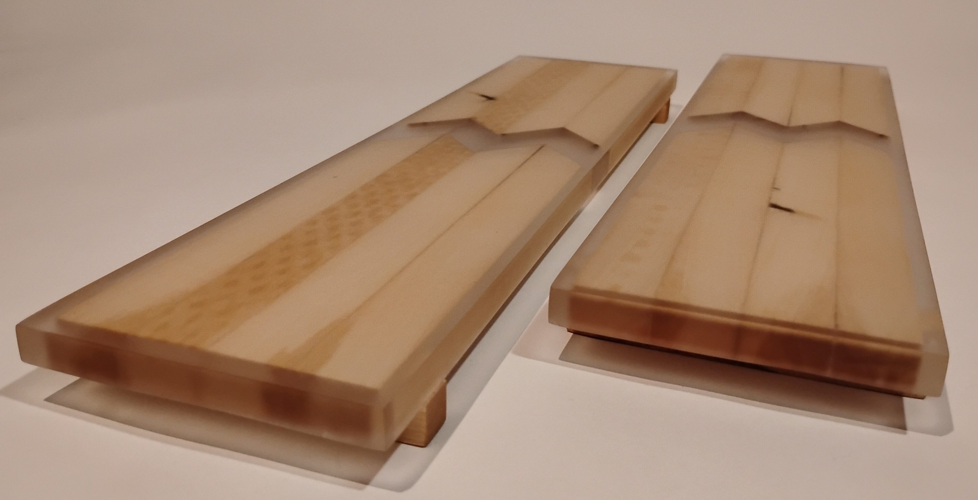 Wooden trays with intricate carved patterns and compartments.