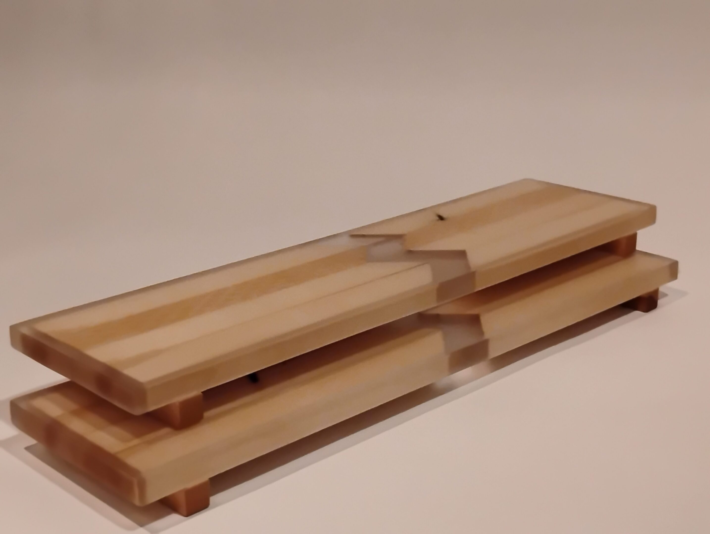 Stacked wooden trays with a smooth finish.