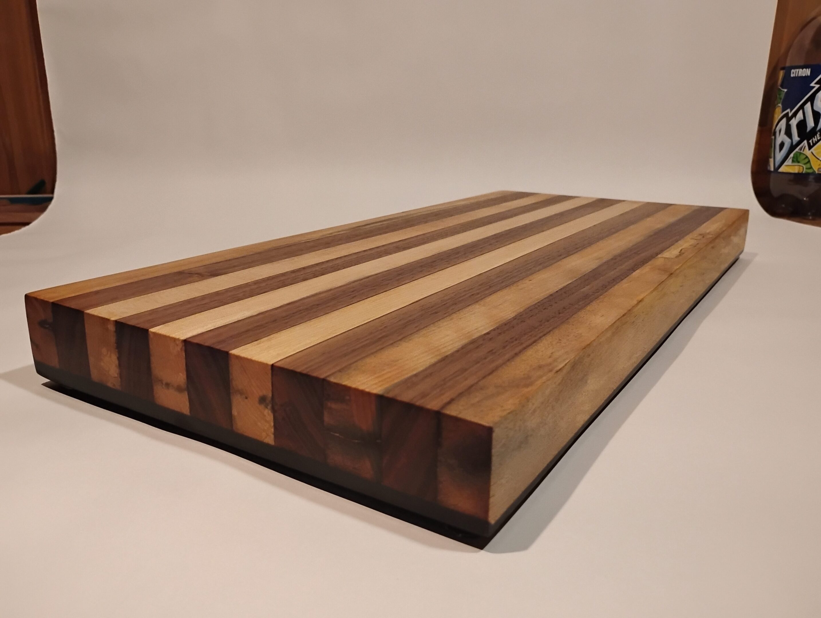 Striped wooden cutting board with smooth finish.