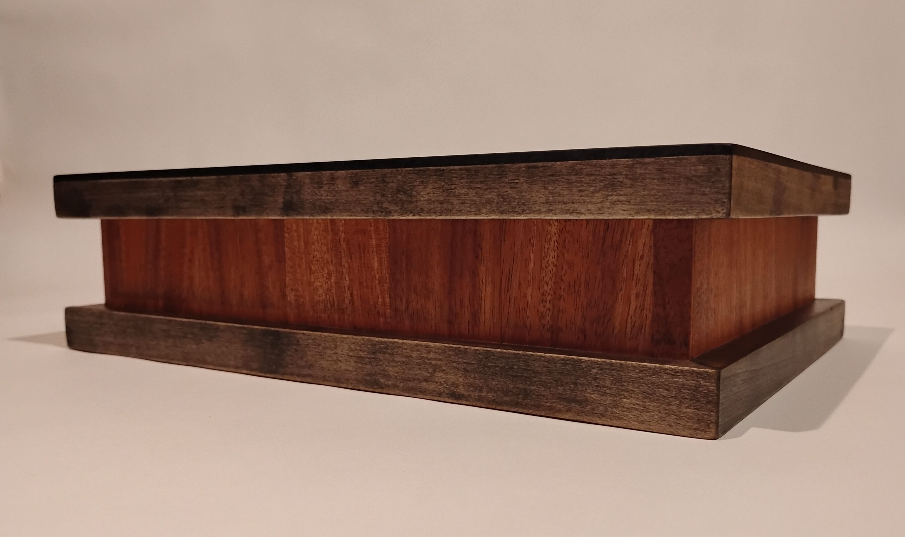 Wooden furniture piece with a mix of dark and reddish wood tones.