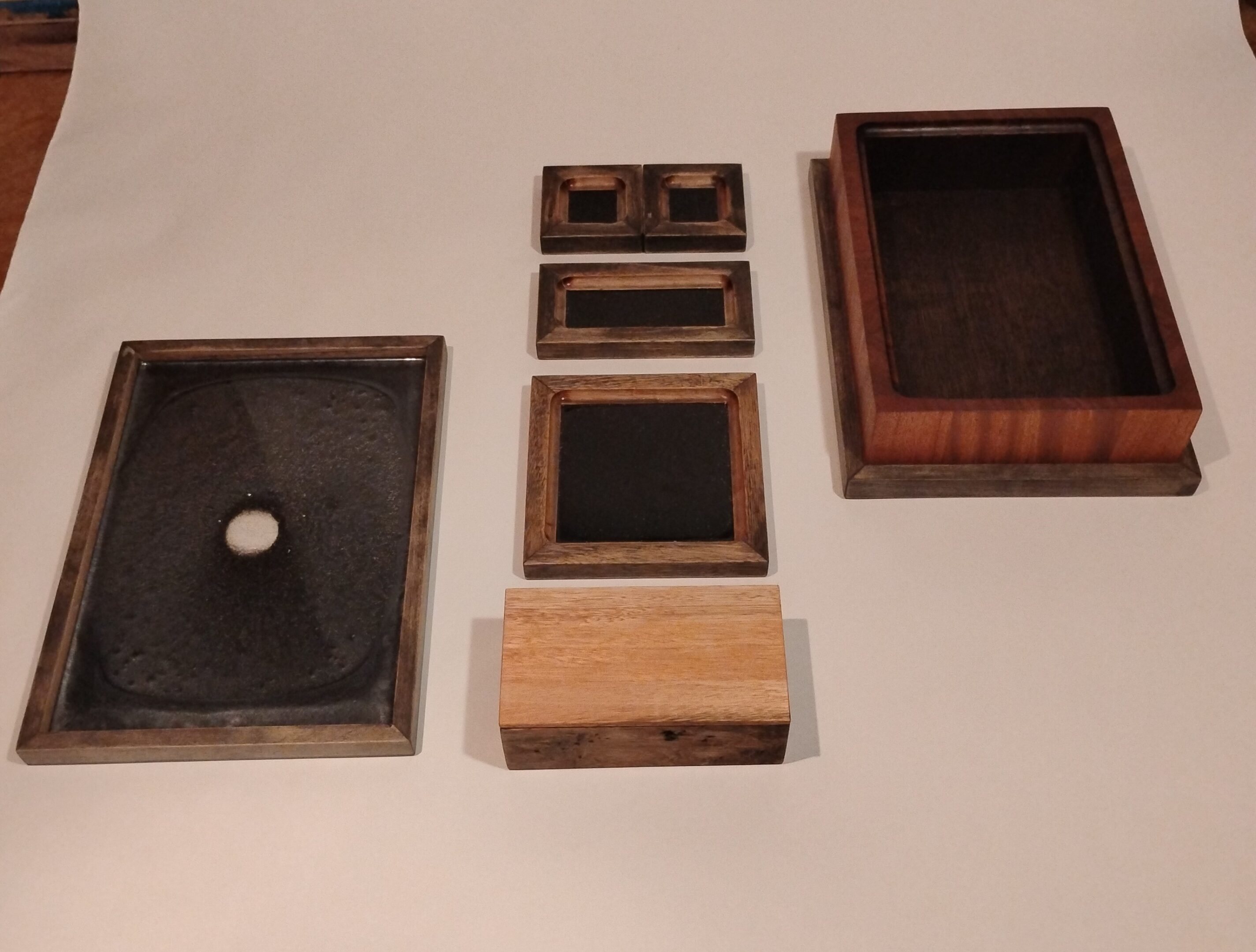 Various wooden frames and boxes arranged on a surface.