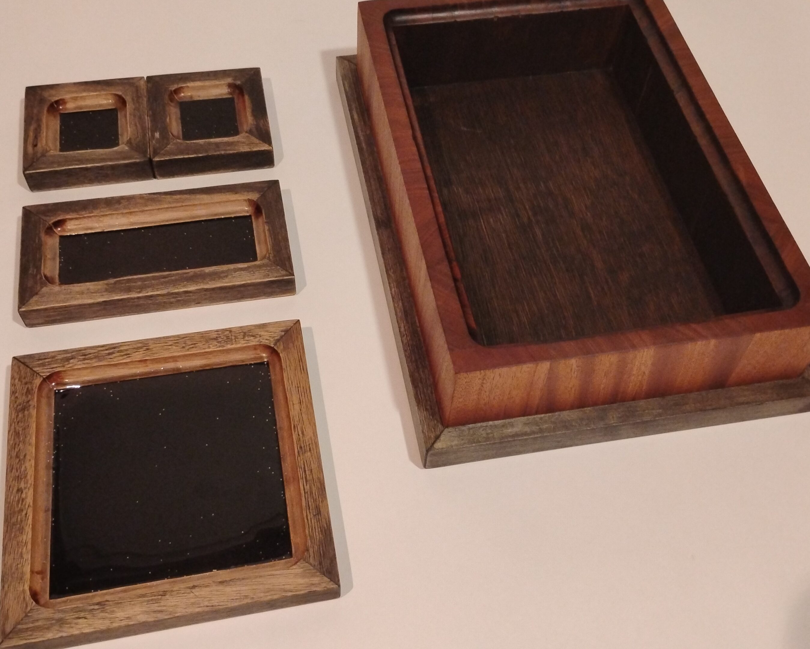 Wooden frames of various sizes arranged on a flat surface.