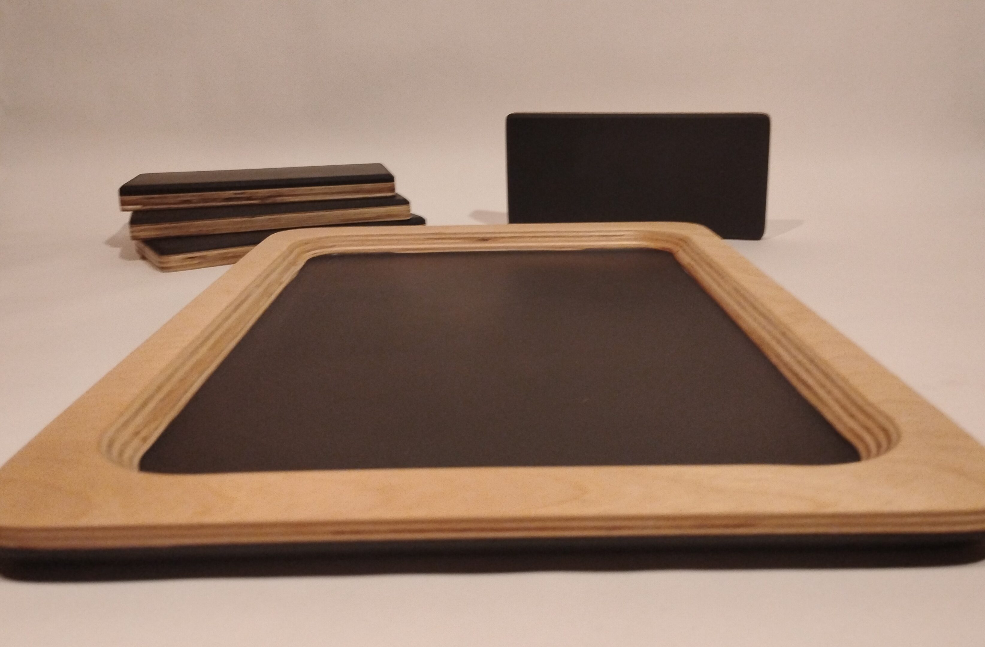 Close-up of a blank wooden-framed chalkboard on a table.