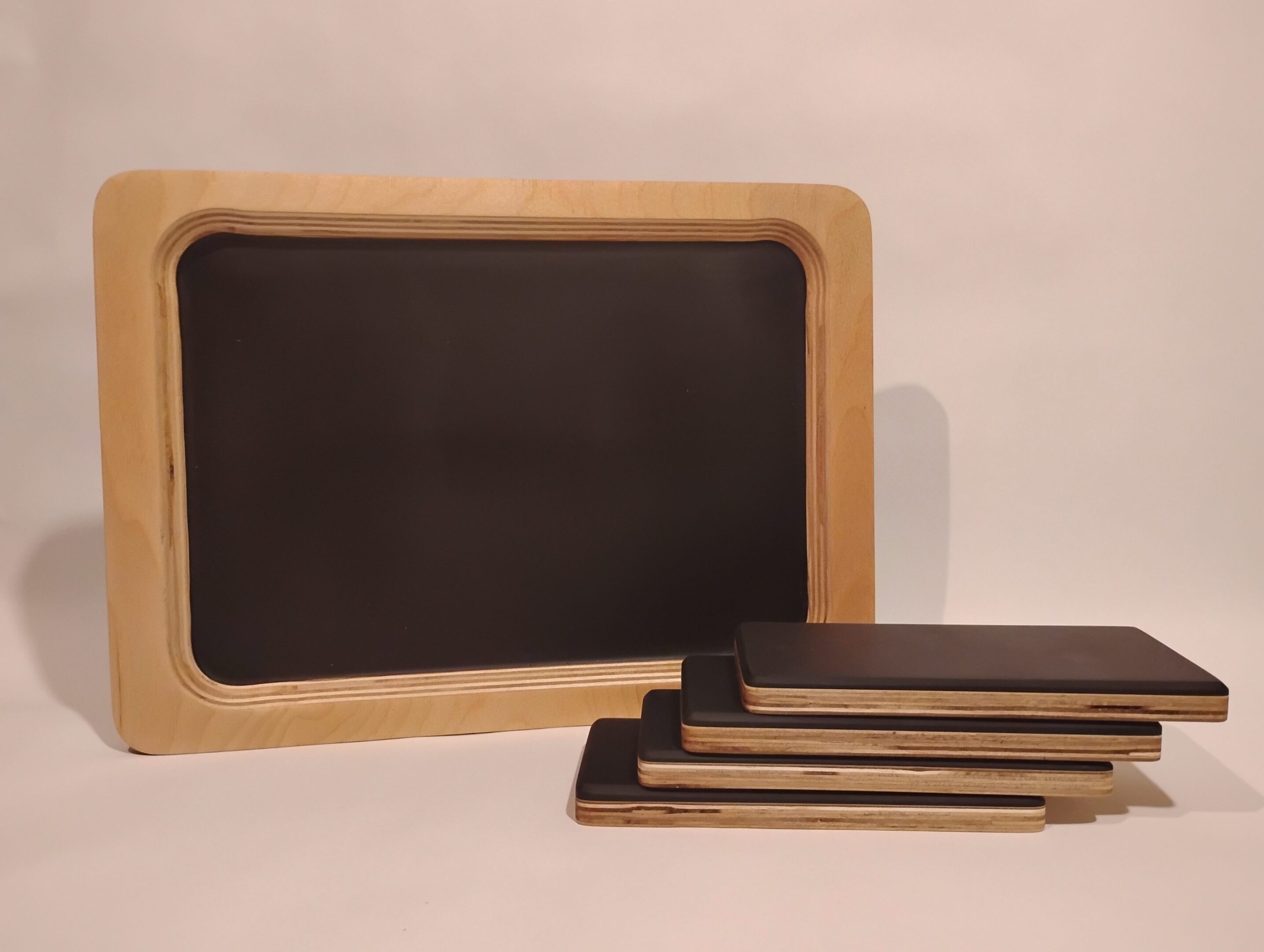 Small wooden-framed chalkboards with blank surfaces.
