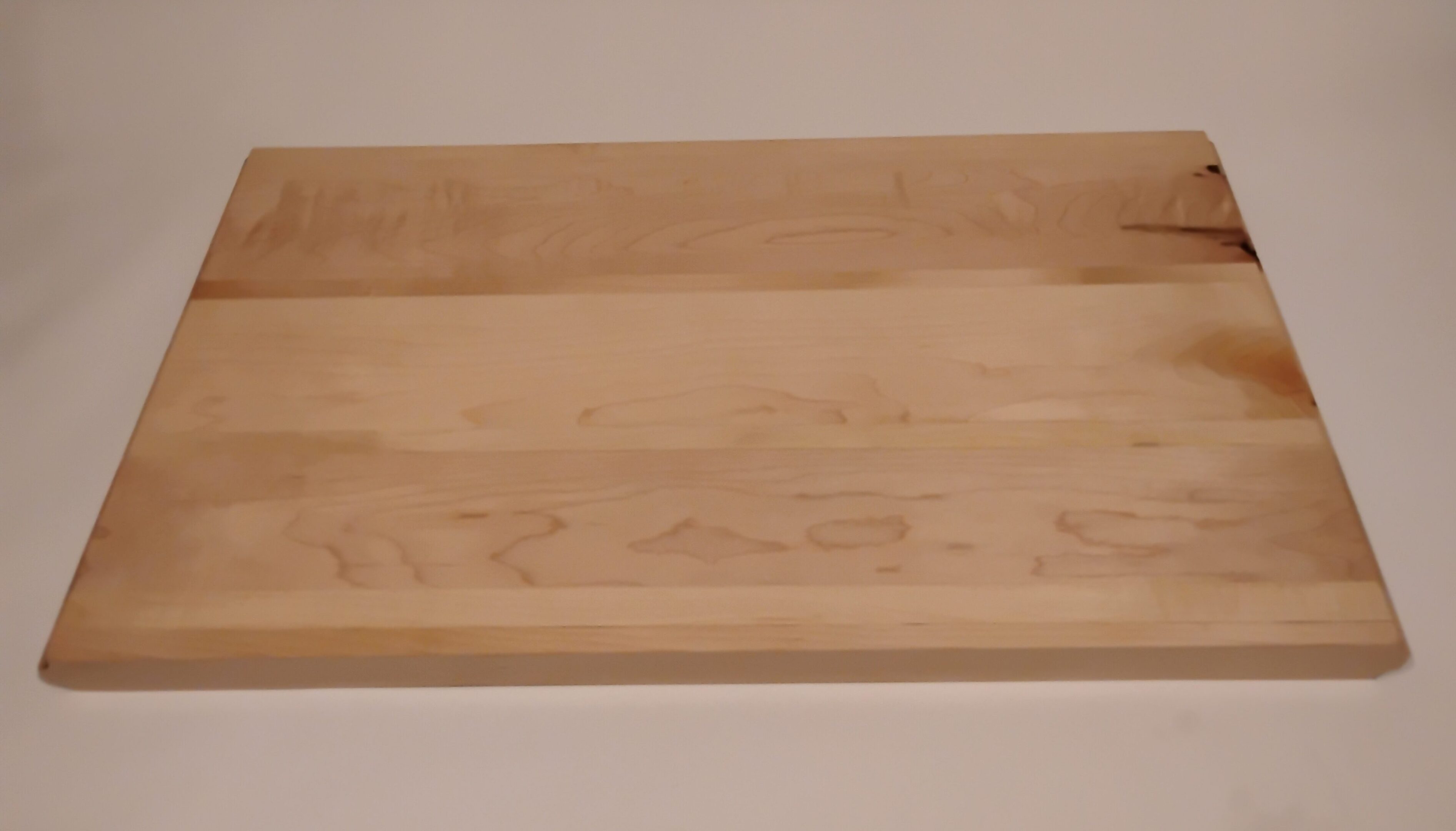 A wooden tray with a light natural finish.