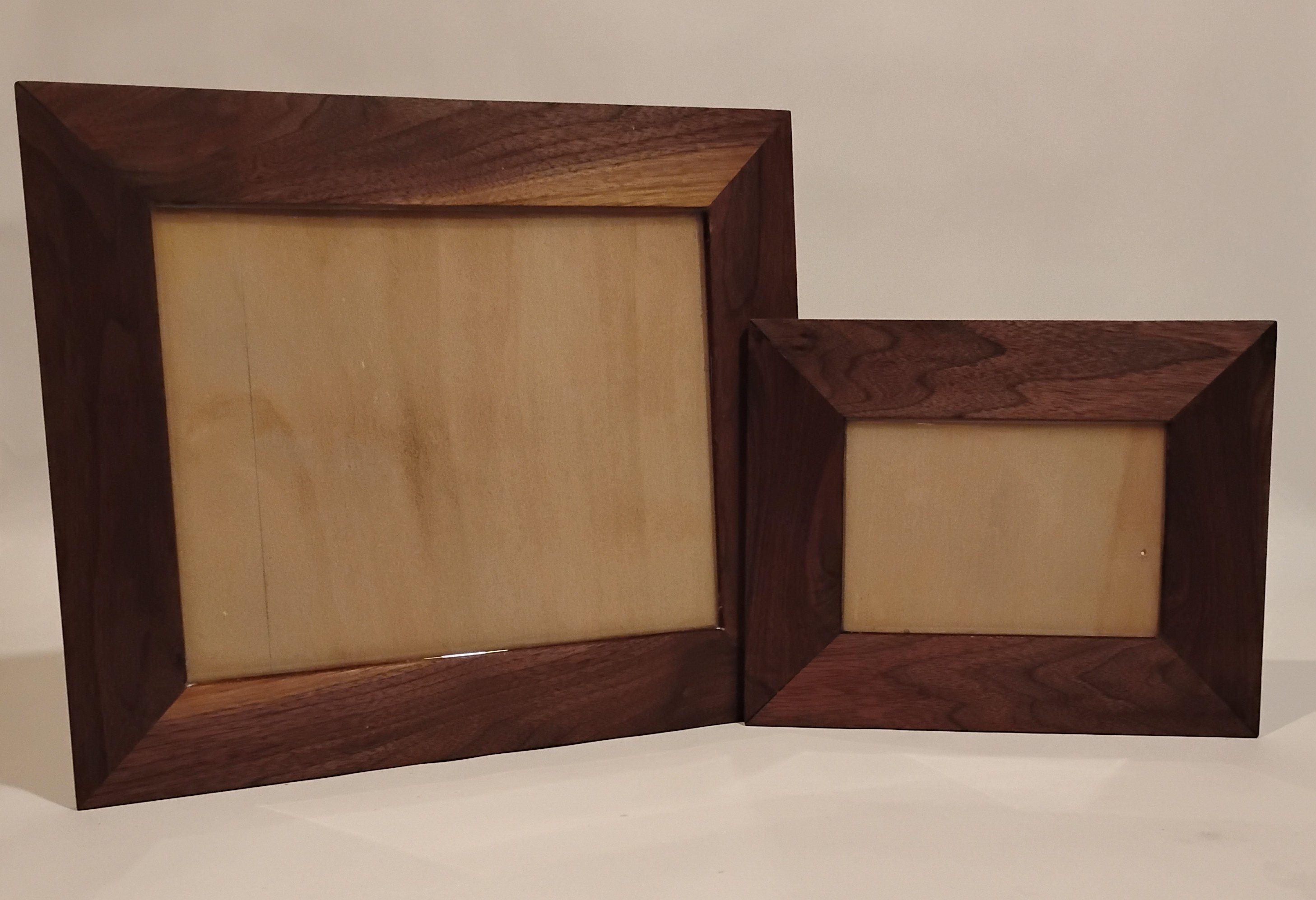 Two wooden picture frames, one large and one small, with a simple design.
