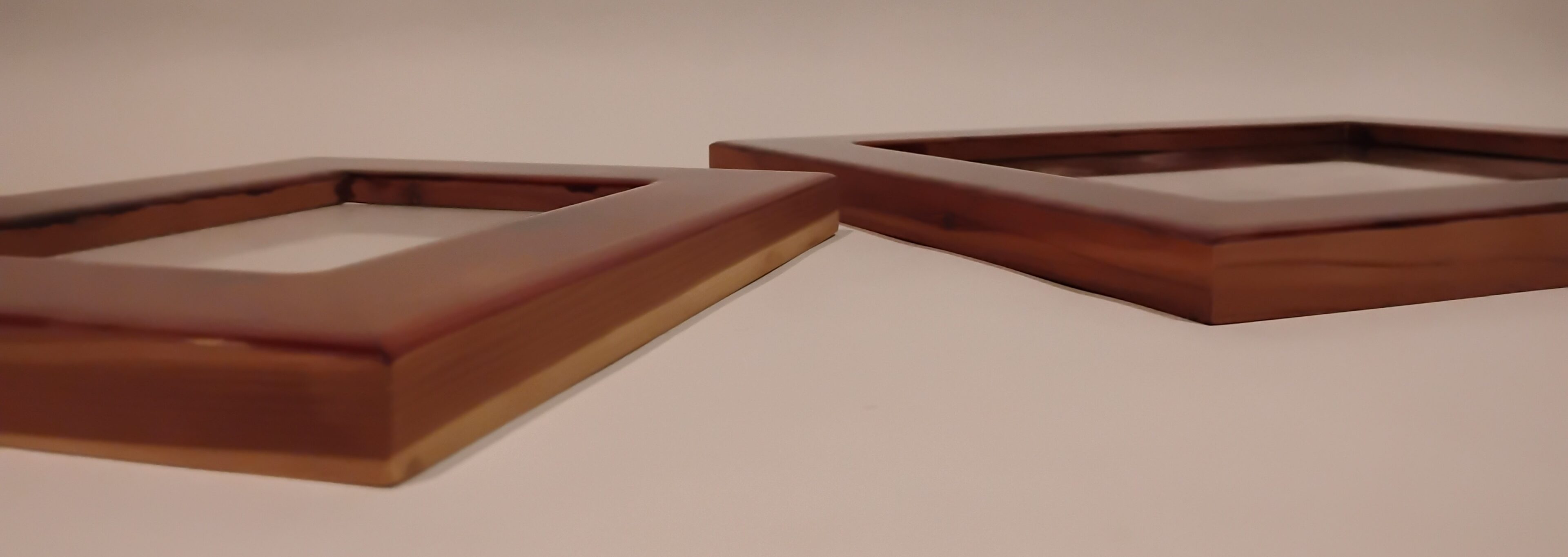 Close-up of intersecting wooden frames with a smooth finish.