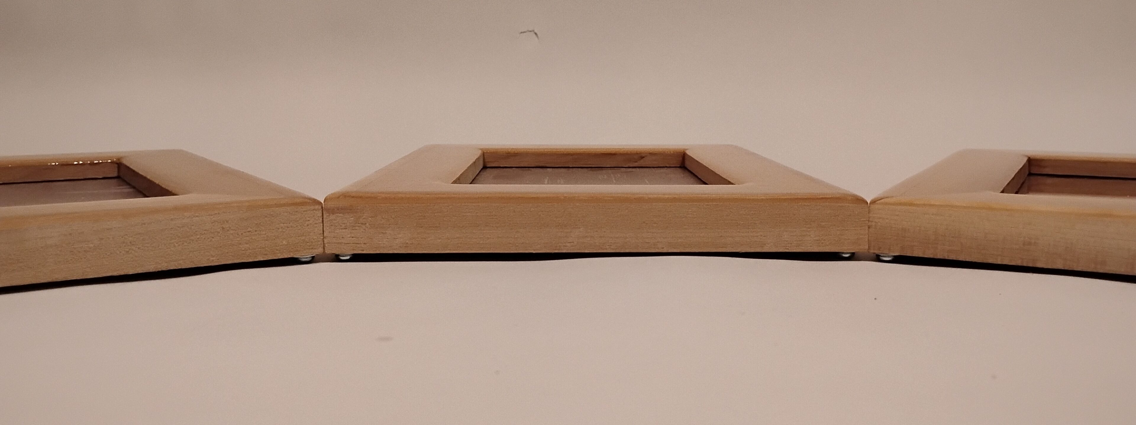 Side view of a wooden picture frame on a plain surface.