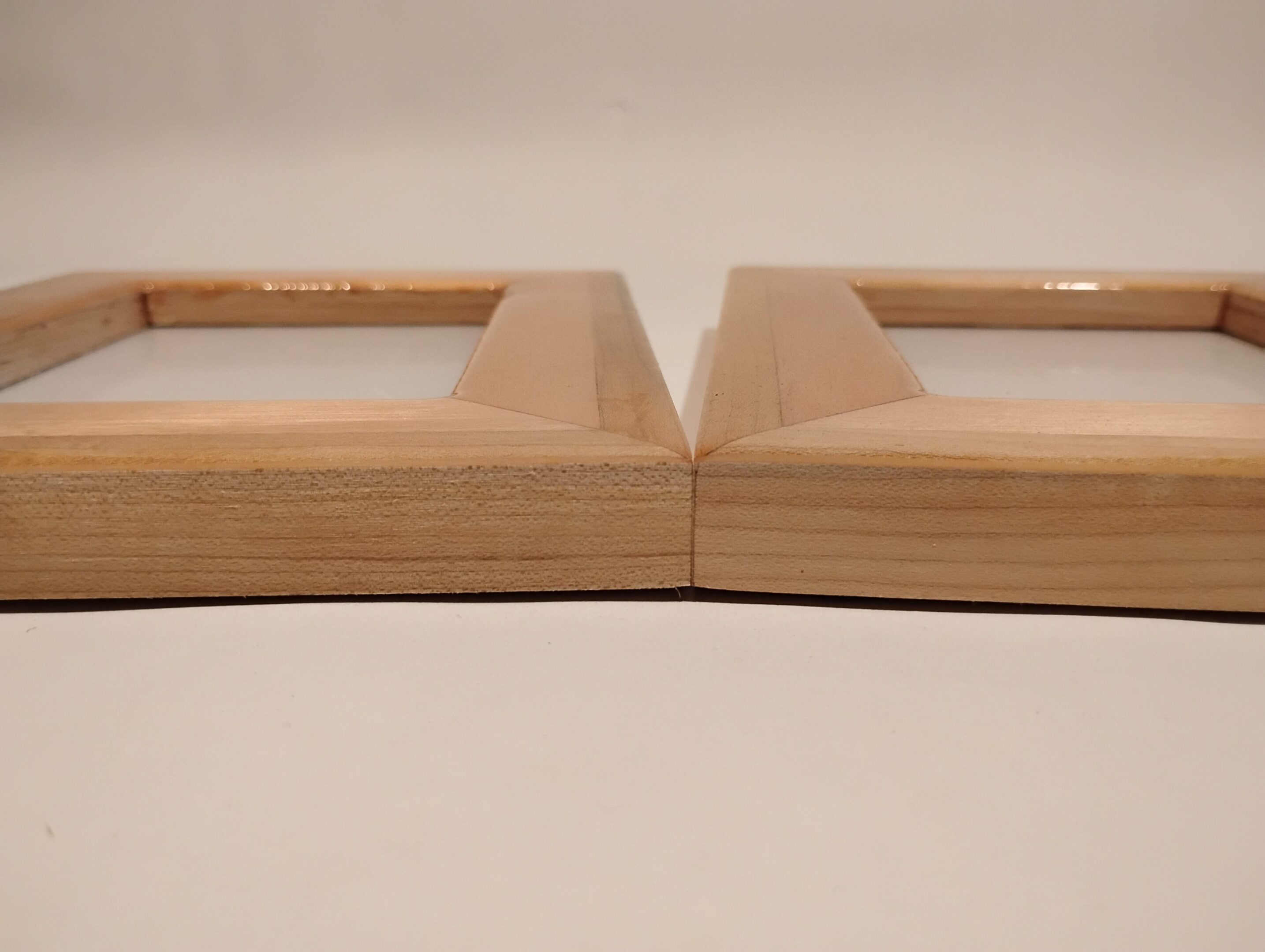 Two wooden frames placed side by side on a flat surface.