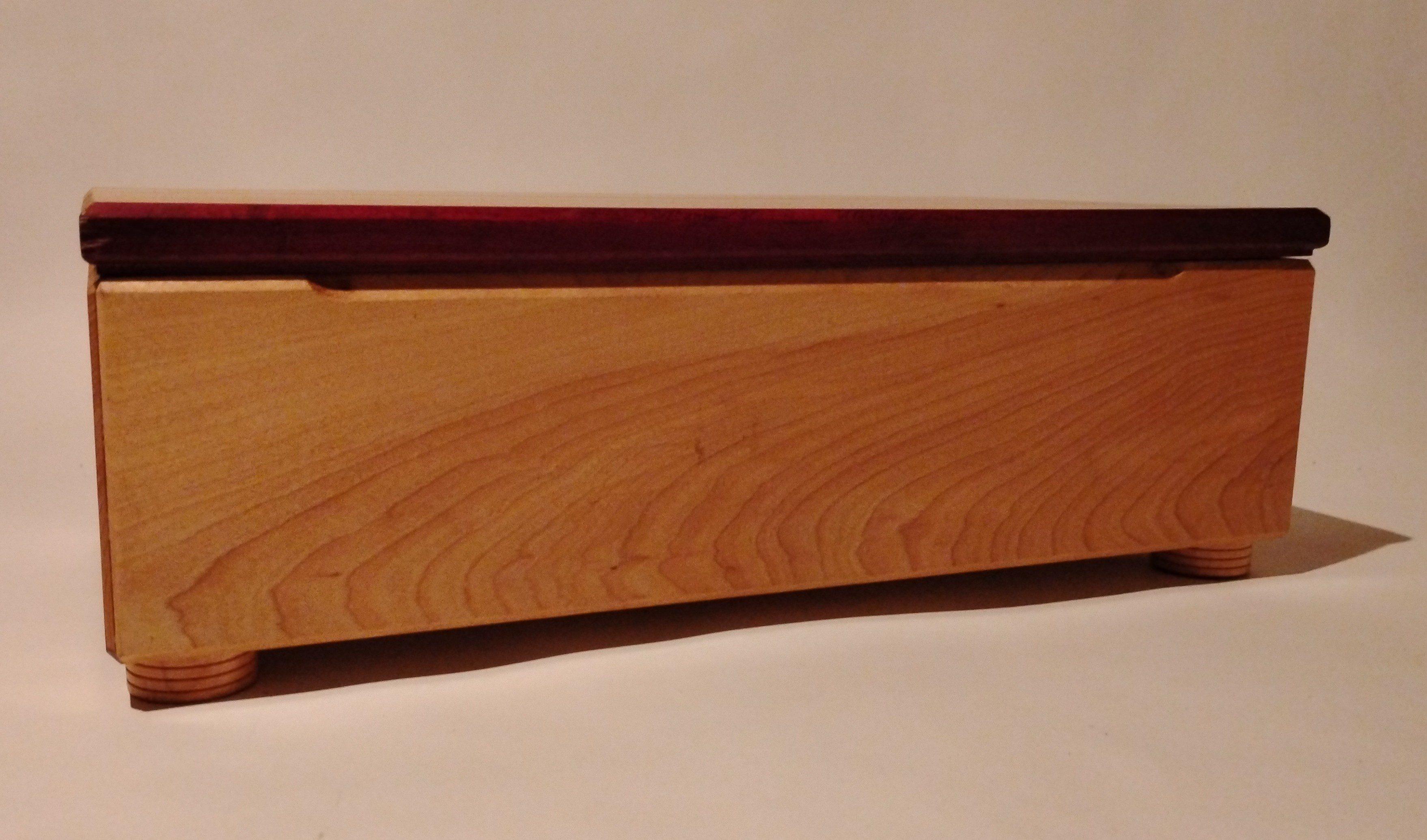 A pool cue stick resting on a white surface.