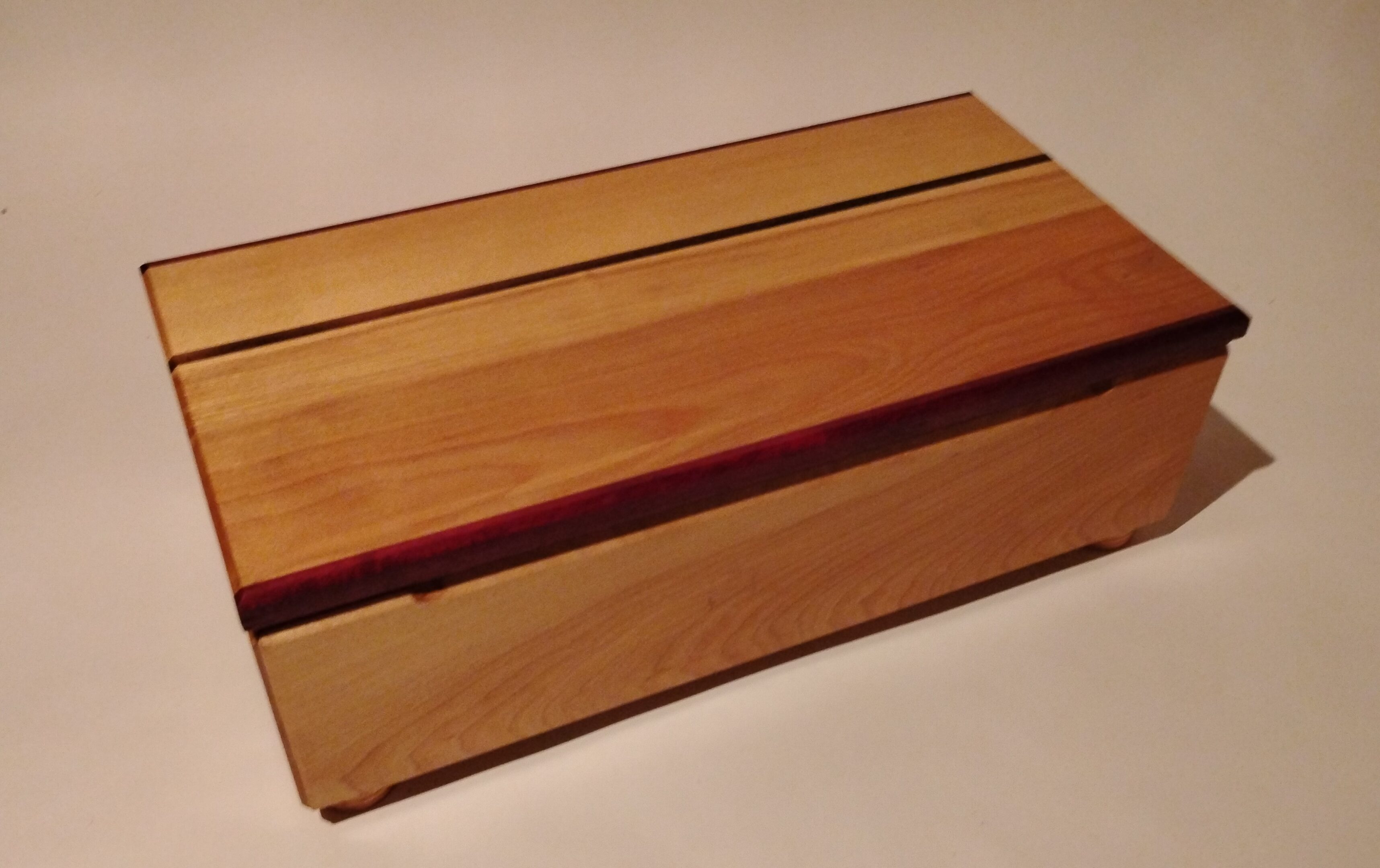 A wooden box with a simple, striped design.