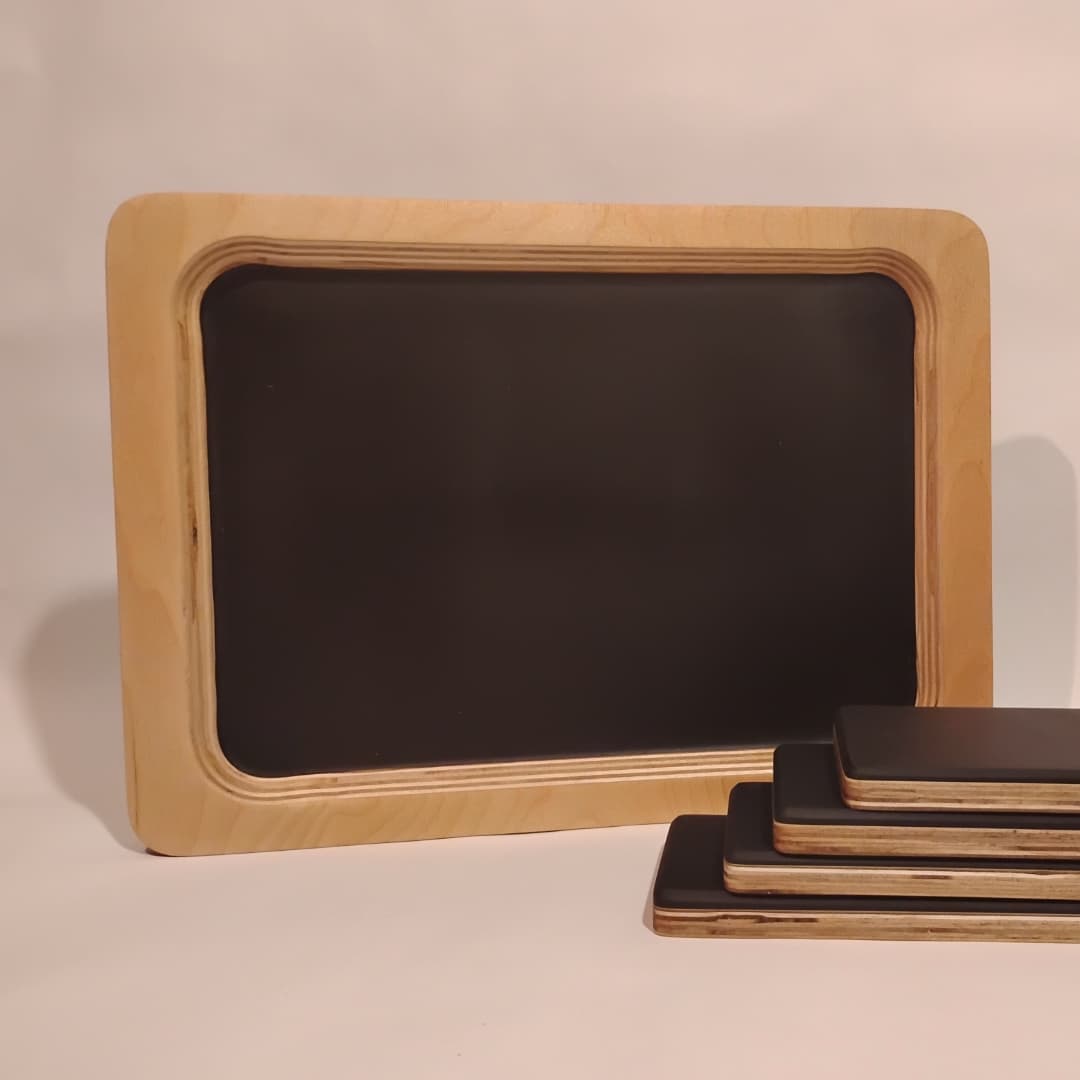 Small rectangular chalkboard with wooden frame and chalk sticks.