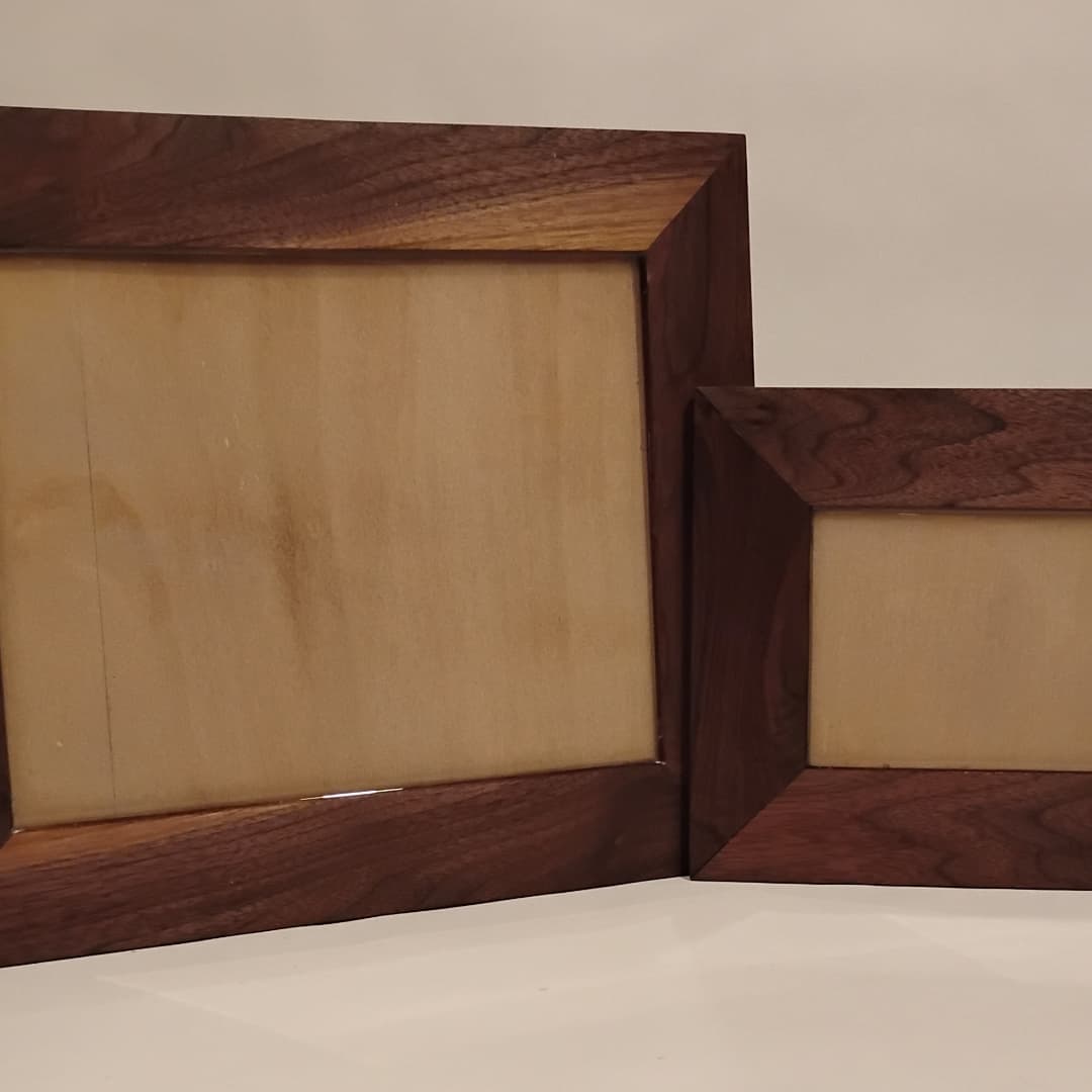 Two wooden picture frames, one large and one small, with a natural wood finish.