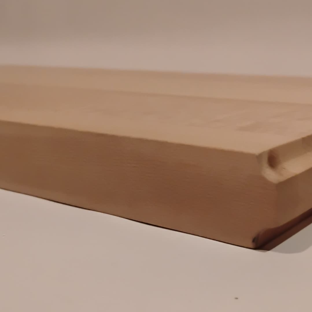 Close-up of a wooden cutting board with a juice groove.