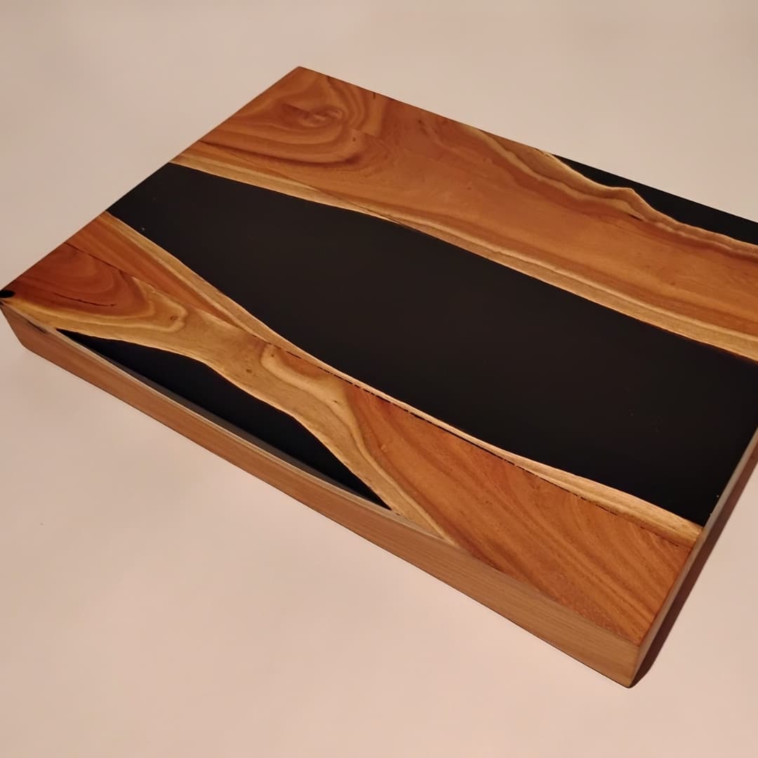 Wood and resin board with smooth, artistic contrasting patterns.