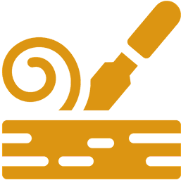 Chisel carving wood with a wood shaving.
