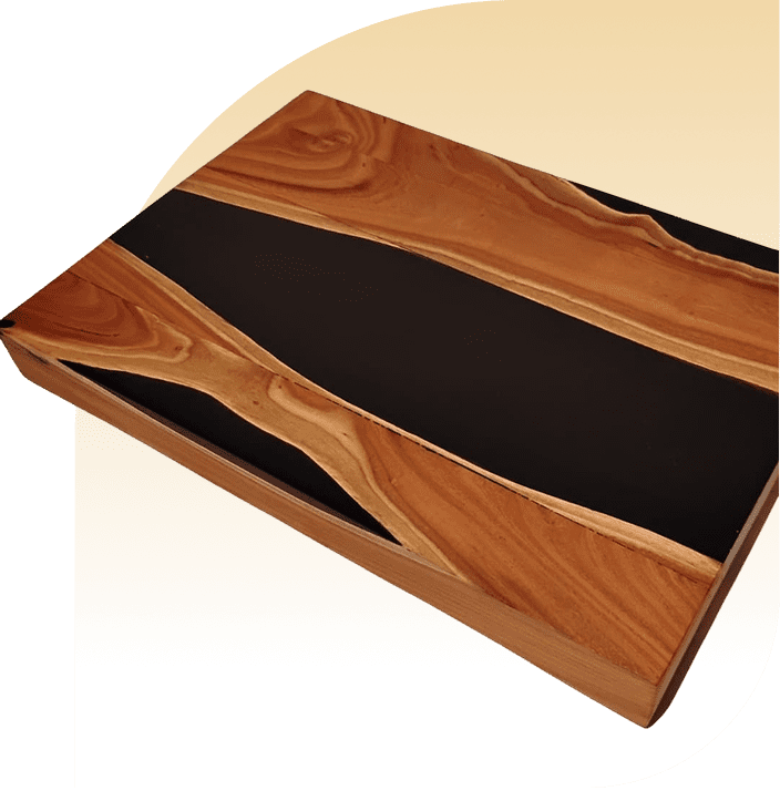 Wooden tray with black resin details on a textured surface.
